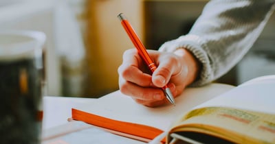 A person writing in a journal.