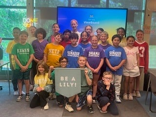 Jarred Fitzkee's class holding a "Be a Lily" banner