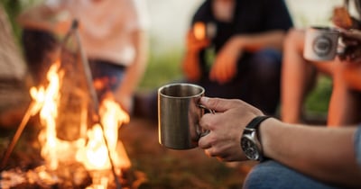 Image of group gathered around a bonfire having an effective team meeting.