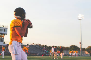 Football player preparing to throwing a football across a field