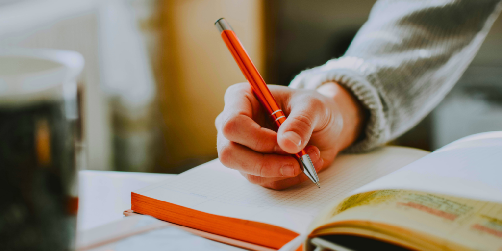 A person writing in a journal.